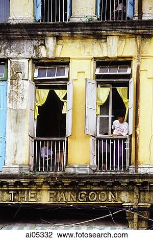 Myanmar (Burma), Yangon (Rangoon), A man looking out of a window in an old colonial building. View Large Photo Image Stock Image - Myanmar (Burma), Yangon (Rangoon), A man looking out of a window in an old colonial building.. Fotosearch