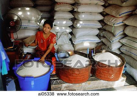 Myanmar (Burma), Yangon (Rangoon), A Burmese woman selling rice of varying grades of quality in a market in Yangon. View Large Photo Image Stock Photo - Myanmar (Burma), Yangon (Rangoon), A Burmese woman selling rice of varying grades of quality in a market in Yangon.. Fotosearch