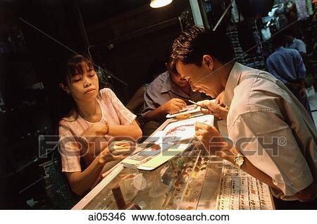 Myanmar (Burma), Yangon (Rangoon), A shopper considering gemstones in Bogyoke Aung San Market, commonly known as Scott's Market. View Large Photo Image Stock Photograph - Myanmar (Burma), Yangon (Rangoon), A shopper considering gemstones in Bogyoke Aung San Market, commonly known as Scott's Market.. Fotosearch