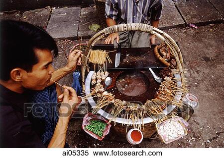Myanmar (Burma), Yangon (Rangoon), A Burmese man enjoying street food in a market. Burmese food blends Bamar, Mon, Indian, and Chinese influences. View Large Photo Image Stock Photography - Myanmar (Burma), Yangon (Rangoon), A Burmese man enjoying street food in a market. Burmese food blends Bamar, Mon, Indian, and Chinese influences.. Fotosearch