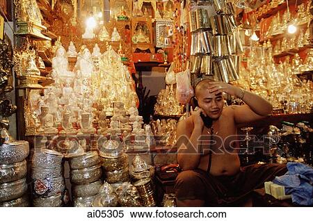 Stock Photography - Myanmar (Burma), Yangon (Rangoon), Monk tending shop at the Shwedagon Pagoda.. Fotosearch