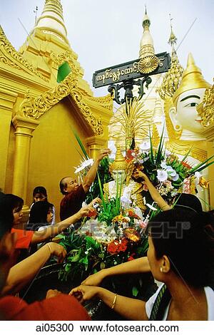Stock Image - Myanmar (Burma), Yangon (Rangoon), Visitors at the Shwedagon Pagoda.. Fotosearch