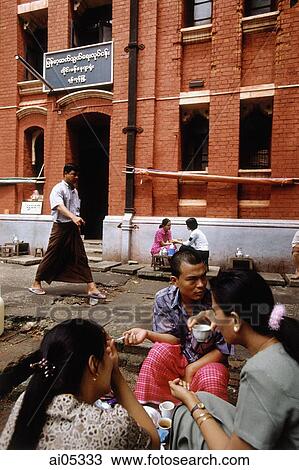 Myanmar (Burma), Yangon (Rangoon), Groups of people having tea and snacks outside a colonial brick building. View Large Photo Image Stock Image - Myanmar (Burma), Yangon (Rangoon), Groups of people having tea and snacks outside a colonial brick building.. Fotosearch