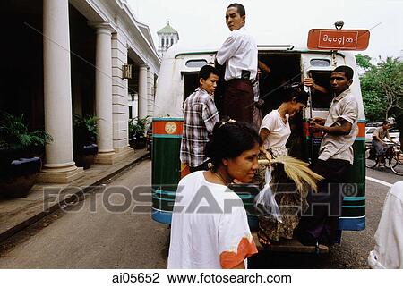 Myanmar (Burma), Yangon (Rangoon), Burmese disembarking from one of the 50-year-old buses in front of the British colonial era Strand Hotel. View Large Photo Image Stock Image - Myanmar (Burma), Yangon (Rangoon), Burmese disembarking from one of the 50-year-old buses in front of the British colonial era Strand Hotel.. Fotosearch