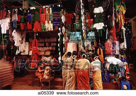 Stock Photo - Myanmar (Burma), Yangon (Rangoon), Shoppers examining Chinese-made consumer goods in a market.. Fotosearch