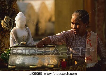 Myanmar (Burma), Yangon, Shwedagon Paya, Worshipper at Washing Buddha image at planetary post. View Large Photo Image Stock Image - Myanmar (Burma), Yangon, Shwedagon Paya, Worshipper at Washing Buddha image at planetary post.. Fotosearch