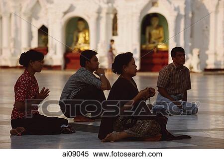 Stock Photography - Myanmar (Burma), Yangon, Worshippers praying at Shwedagon Paya.. Fotosearch