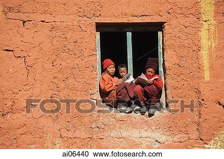 Nepal, Lo Manthang, Young monks sit on window sill and study for exams View Large Photo Image Stock Image - Nepal, Lo Manthang, Young monks sit on window sill and study for exams. Fotosearch