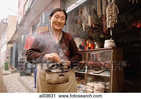 Nepal, Tibetan woman with juniper incense View Large Photo Image Stock Image - Nepal, Tibetan woman with juniper incense. Fotosearch