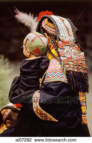 Pakistan, Chitral, Rumbur Valley, Kailash woman holding child in traditional costume. View Large Photo Image Stock Image - Pakistan, Chitral, Rumbur Valley, Kailash woman holding child in traditional costume.. Fotosearch