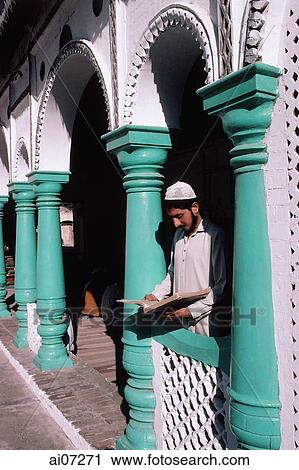 Pakistan, Northern Areas, Chitral, Male student reading the Koran in front of mosque. View Large Photo Image Stock Image - Pakistan, Northern Areas, Chitral, Male student reading the Koran in front of mosque.. Fotosearch