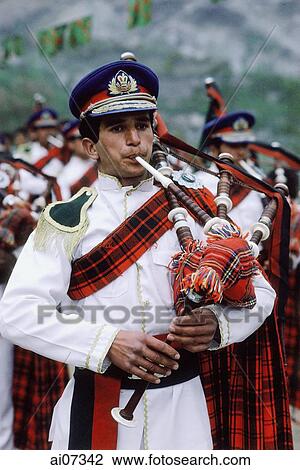 Stock Image - Pakistan, Northern Areas, Hunza Valley, Military band in uniforms playing bagpipes.. Fotosearch