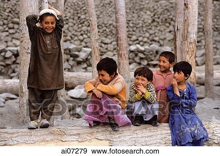 Pakistan, Northern Areas, Hunza Valley, Karimabad, Children gather by log. View Large Photo Image Stock Photo - Pakistan, Northern Areas, Hunza Valley, Karimabad, Children gather by log.. Fotosearch