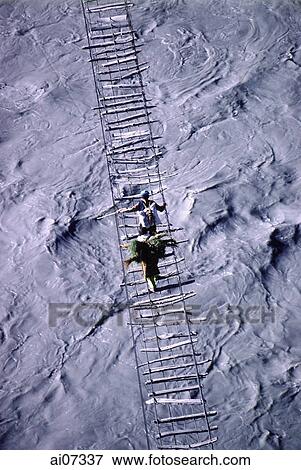Pakistan, Northern Areas, Hunza Valley, Villagers crossing rope bridge. View Large Photo Image Stock Photo - Pakistan, Northern Areas, Hunza Valley, Villagers crossing rope bridge.. Fotosearch