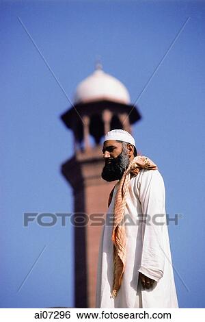 Pakistan, Punjab, Lahore, Badashi Mosque, Man in front of mosque. View Large Photo Image Stock Photograph - Pakistan, Punjab, Lahore, Badashi Mosque, Man in front of mosque.. Fotosearch