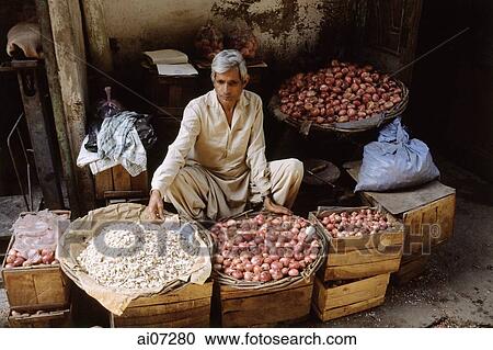 Pakistan, Punjab, Lahore, Man in street stall selling onions and garlic View Large Photo Image Stock Image - Pakistan, Punjab, Lahore, Man in street stall selling onions and garlic. Fotosearch