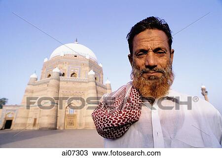 Stock Image - Pakistan, Punjab, Multan, Man standing in front of Shrine of Sheik Rukni-I-Alam.. Fotosearch