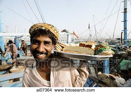 Pakistan, Sind, Karachi, West Wharf Harbor, Man selling cakes at wharf. View Large Photo Image Picture - Pakistan, Sind, Karachi, West Wharf Harbor, Man selling cakes at wharf.. Fotosearch