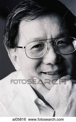 Stock Photograph - Portrait of man resting chin on hand. Fotosearch