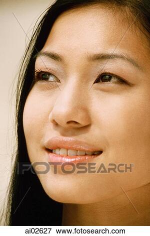 Stock Photo - Portrait of young woman looking away. Fotosearch