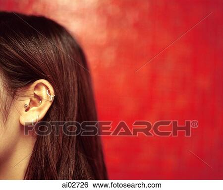 Profile of ear and hair of young woman, red background. View Large Photo Image Stock Photograph - Profile of ear and hair of young woman, red background.. Fotosearch