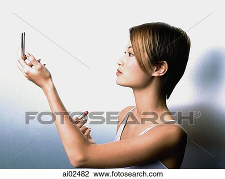 Profile of woman looking in compact mirror View Large Photo Image Stock Image - Profile of woman looking in compact mirror. Fotosearch