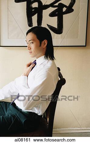 Profile of young man wearing white shirt adjusting tie, sitting. View Large Photo Image Stock Image - Profile of young man wearing white shirt adjusting tie, sitting.. Fotosearch