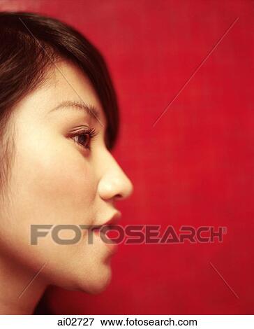 Profile of young woman, red/orange background. View Large Photo Image Stock Photo - Profile of young woman, red/orange background.. Fotosearch