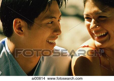 Profile of young woman smiling at young man View Large Photo Image Picture - Profile of young woman smiling at young man. Fotosearch