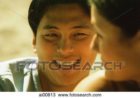 Profile of young woman smiling at young man View Large Photo Image Stock Image - Profile of young woman smiling at young man. Fotosearch
