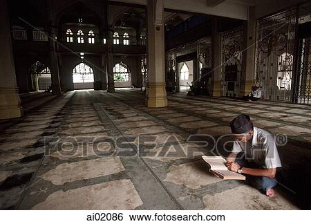 Singapore, Arab Street, Muslim man reads Koran in Mosque. View Large Photo Image Stock Photograph - Singapore, Arab Street, Muslim man reads Koran in Mosque.. Fotosearch