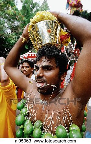 Stock Image - Singapore, Hindu devotee with body piercings during Thaipusam festival. Fotosearch