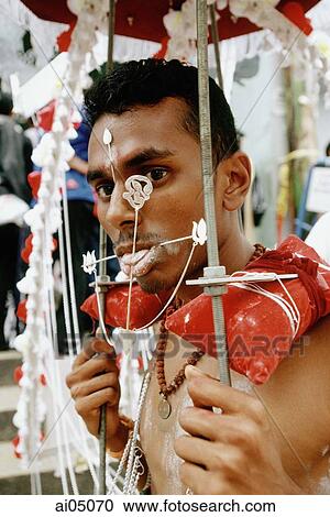 Singapore, Hindu devotee with body piercings during Thaipusam festival View Large Photo Image Stock Image - Singapore, Hindu devotee with body piercings during Thaipusam festival. Fotosearch