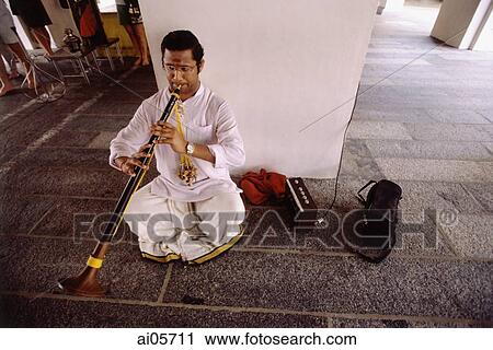 Singapore, Little India, Man sitting on floor playing clarinet. View Large Photo Image Stock Image - Singapore, Little India, Man sitting on floor playing clarinet.. Fotosearch