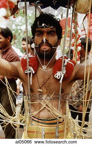Stock Photograph - Singapore, Young devotee with Hindu icons during Thaipusam festival. Fotosearch