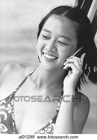 Teen girl talking on cellular phone, smiling View Large Photo Image Stock Photo - Teen girl talking on cellular phone, smiling. Fotosearch