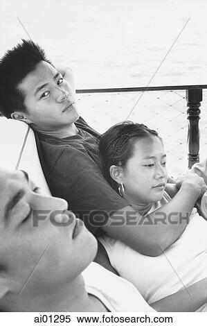 Teenagers relaxing on deck of boat View Large Photo Image Stock Photography - Teenagers relaxing on deck of boat. Fotosearch