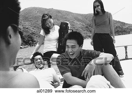 Teenagers sitting on deck of boat talking View Large Photo Image Stock Photo - Teenagers sitting on deck of boat talking. Fotosearch