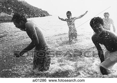 Teenagers splashing in the ocean View Large Photo Image Stock Photograph - Teenagers splashing in the ocean. Fotosearch