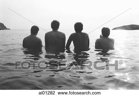 Teenagers wading in ocean, rear view, silhouette View Large Photo Image Stock Image - Teenagers wading in ocean, rear view, silhouette. Fotosearch