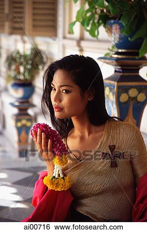 Thai woman holding flowers View Large Photo Image Stock Photograph - Thai woman holding flowers. Fotosearch