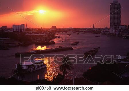 Stock Photo - Thailand, Bangkok, Chao Praya River, Barges at sunset. Fotosearch