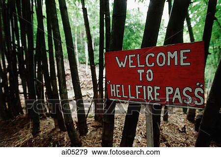 Stock Photo - Thailand, Kanchanaburi, Hellfire Pass, A hand-painted sign welcomes visitors to the beginning of the Hellfire Pass trail.. Fotosearch