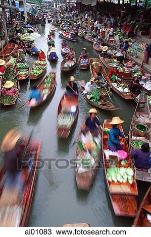 Stock Image - Thailand, Ratchaburi province, Ratchaburi floating market, traders and boats. Fotosearch