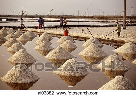 Stock Image - Thailand, Sea salt harvest.. Fotosearch