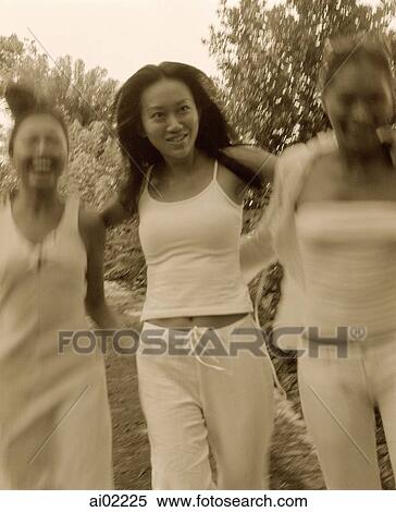 Three women wearing white strolling, holding hands, nature in background View Large Photo Image Stock Photography - Three women wearing white strolling, holding hands, nature in background. Fotosearch