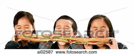 Three young children (two girls, one boy) eating large sandwich, white background. View Large Photo Image Stock Photo - Three young children (two girls, one boy) eating large sandwich, white background.. Fotosearch