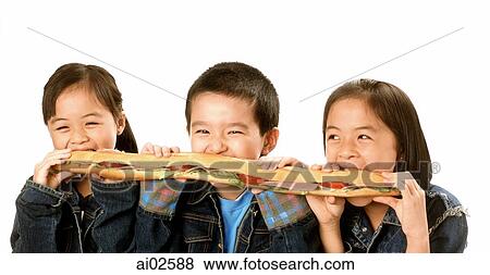 Three young children (two girls, one boy) eating large sandwich, white background. View Large Photo Image Stock Photo - Three young children (two girls, one boy) eating large sandwich, white background.. Fotosearch