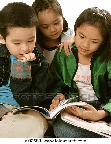 Three young children (two girls, one boy) reading books. View Large Photo Image Stock Photo - Three young children (two girls, one boy) reading books.. Fotosearch