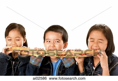 Three young children (two girls, one boy) eating large sandwich, white background. View Large Photo Image Stock Photograph - Three young children (two girls, one boy) eating large sandwich, white background.. Fotosearch